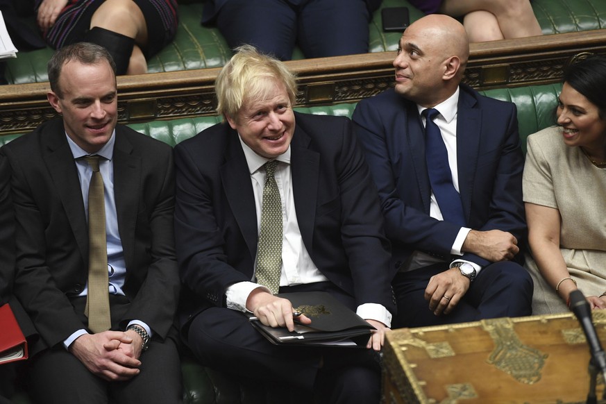 In this photo made available by the UK Parliament, Britain&#039;s Prime Minister Boris Johnson, center, attends the debate in the House of Commons, London, Thursday Dec. 19, 2019. Boris Johnson signal ...