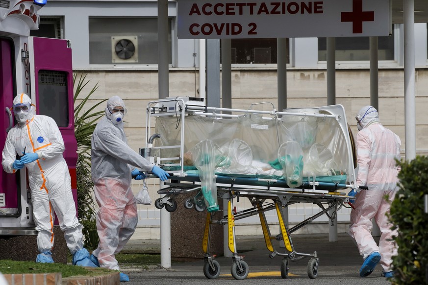 A patient in a biocontainment unit is carried on a stretcher from an ambulance arrived at the Columbus Covid 2 Hospital in Rome, Tuesday, March 17, 2020. For most people, the new coronavirus causes on ...