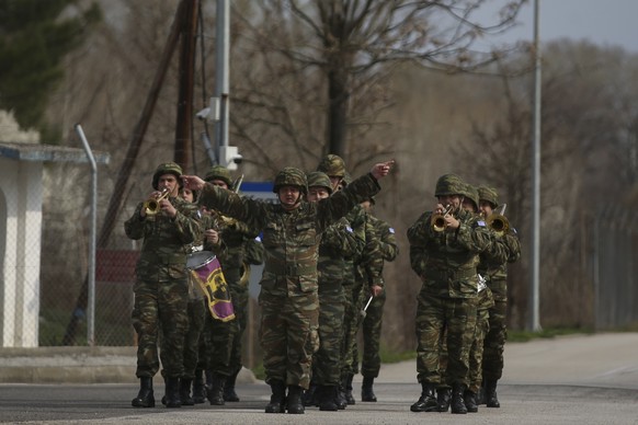 A Greek Army band march at the check point of the Greek-Turkish border in the village of Kastanies, Evros region, Tuesday, March 10, 2020. The European Union should stop &quot;stringing Turkey along&q ...