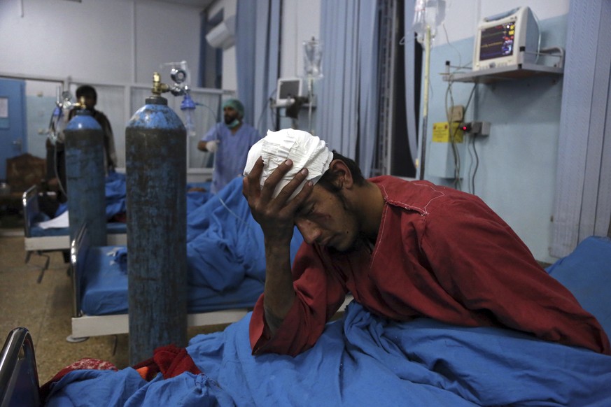 An injured man receives treatment at a hospital after a suicide bombing in Kabul, Afghanistan, Nov. 20, 2018. Afghan officials said the suicide bomber targeted a gathering of Muslim religious scholars ...