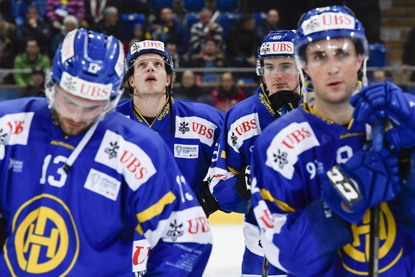 Davos&#039; Robert Kousal, Gregory Sciaroni, Dario Simion and Tino Kessler, from left, look on after loosing the game between HC Davos and Team Canada, at the 90th Spengler Cup ice hockey tournament i ...