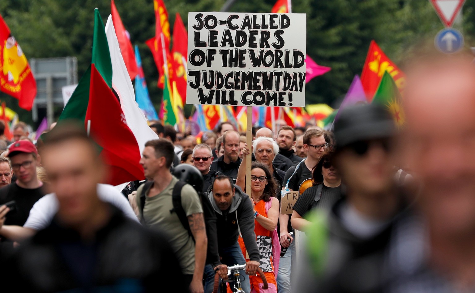 epa06075908 Protesters show a placard reading &#039;So-called leaders of the world, Judgement Day will come&#039; on the &#039;Hamburg shows attitude&#039; demonstration during the G-20 summit in Hamb ...