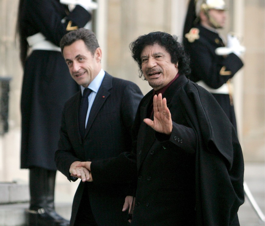 epa06615391 (FILE) - French President Nicolas Sarkozy (L) welcomes Libyan leader Muammar Gaddafi at Palais Elysee, Paris, France, 12 December 2007, (reissued 20 March 2018). Media reports on 20 March  ...