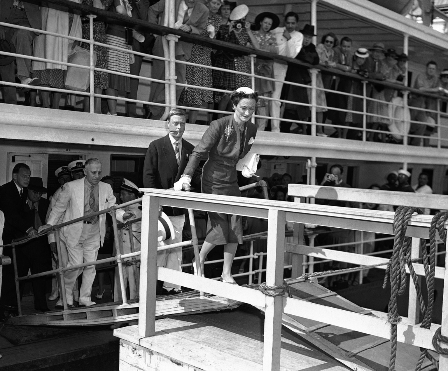 The Duke of Windsor, Prince Edward (dark coat) and his American-born duchess, Wallis Simpson, right, leave the S.S. Berkshire at Miami, Florida on April 18, 1941, for their second U.S. visit since the ...