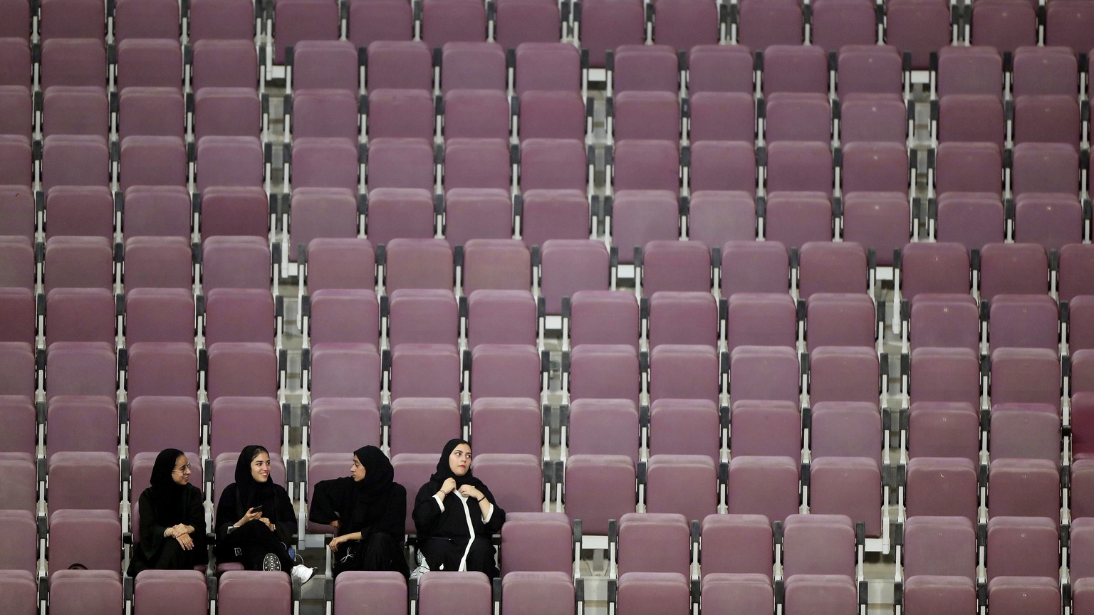 Spectators sit in nearly empty seats the World Athletics Championships in Doha, Qatar, Monday, Sept. 30, 2019. (AP Photo/Hassan Ammar)