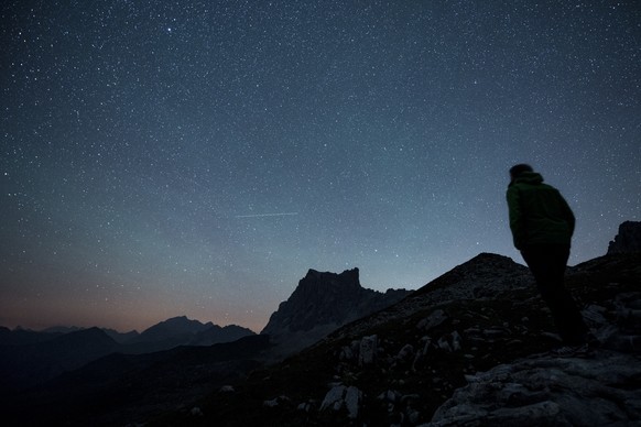 Stars and shooting stars are pictured during the annual perseids meteor shower, with the Drusenfluh mountain (2827 meter above sea level), on Thursday, August 13, 2015, in St. Antoenien in the canton  ...