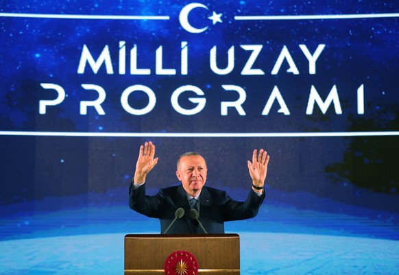 epa08999459 A handout picture provided by the Turkish President Press office shows Turkish President Recep Tayyip Erdogan greets to people during the National Space Program introductory meeting in Ank ...