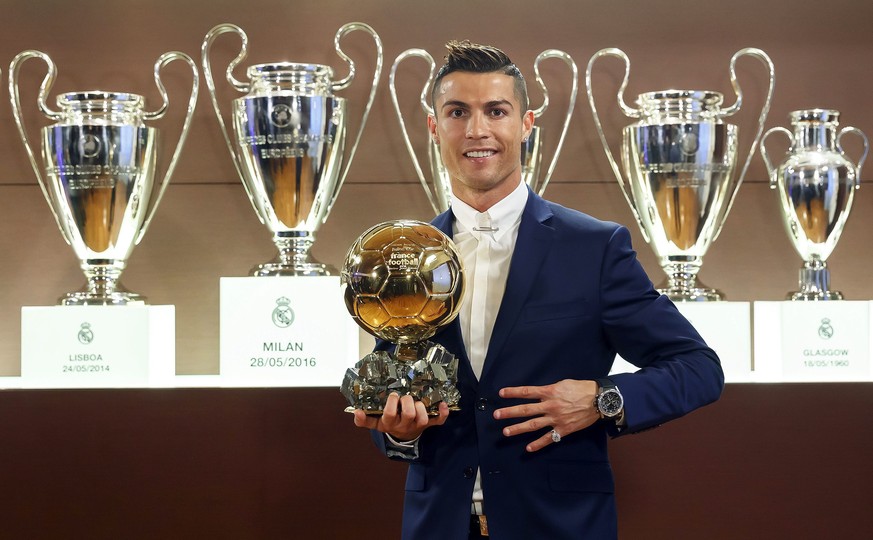 epa05673192 A handout picture provided by France Football on 12 December 2016 of Real Madrid&#039;s Portuguese striker Cristiano Ronaldo posing with the Ballon d&#039;Or 2016 trophy at Bernabeu stadiu ...