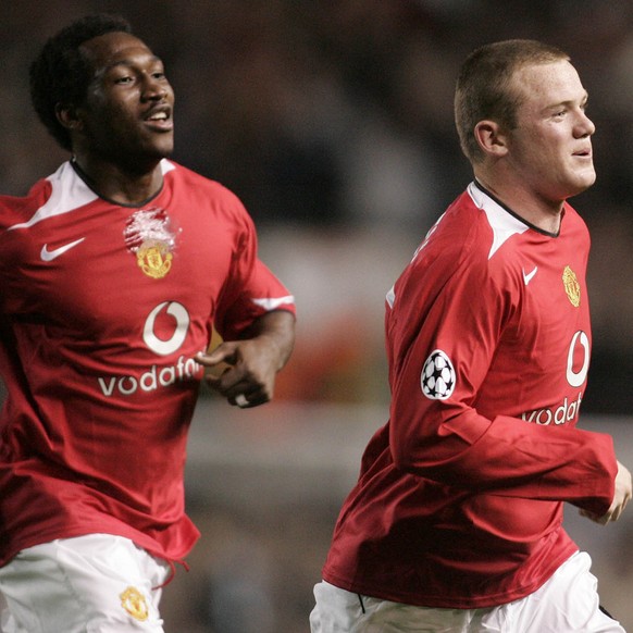 Manchester United&#039;s Wayne Rooney, right, with teammate Eric Djemba Djemba celebrates his third goal and therefore hat trick on his debut against Fenerbahce during their UEFA Champion&#039;s Leagu ...
