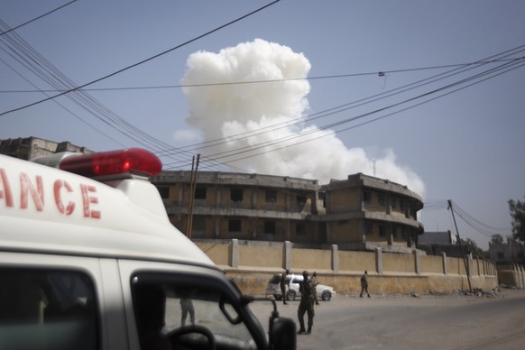 epa07244424 White smoke rises into the sky after the twin explosions near the National Theater in Mogadishu, Somalia, 22 December 2018. A suicide car bomb reportedly exploded at a checkpoint near the  ...