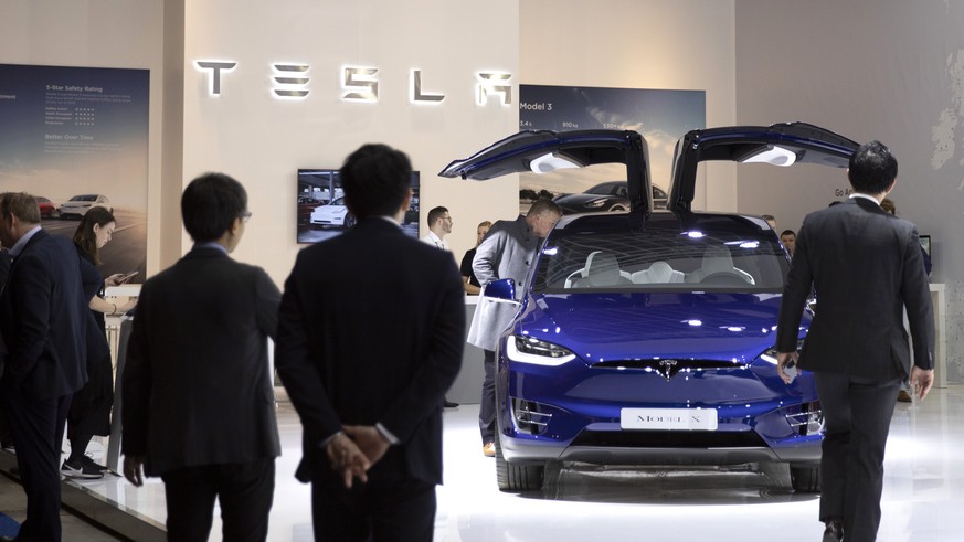 People view the new Tesla Model X during the Brussels Auto Show at the Expo in Brussels, Thursday, Jan. 9, 2020. (AP Photo/Virginia Mayo)