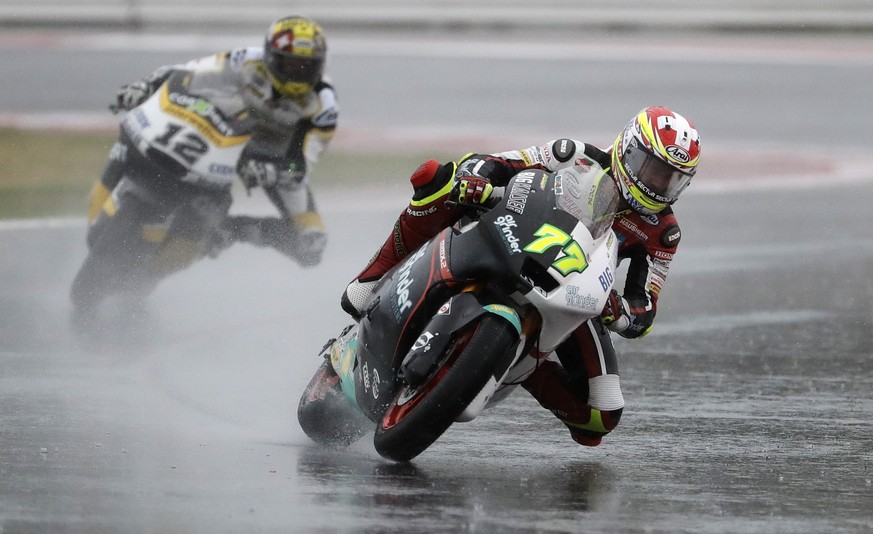 Moto 2 rider Dominique Aegerter of Switzerland takes a curve followed by countryman Thomas Luthi, left, during the San Marino Motorcycle Grand Prix at the Misano circuit in Misano Adriatico, Italy, Su ...