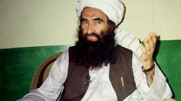 FILE- In this Aug. 22, 1998, file photo, Jalaluddin Haqqani, founder of the militant group the Haqqani network, speaks during an interview in Miram Shah, Pakistan. Taliban say the Afghan Haqqani netwo ...