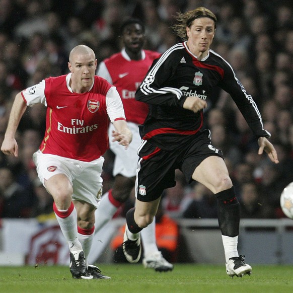 Arsenal&#039;s Philippe Senderos, left, and Liverpool&#039;s Fernando Torres, right, vie for the ball during their Champions League quarterfinal first leg soccer match at Arsenal&#039;s Emirates Stadi ...