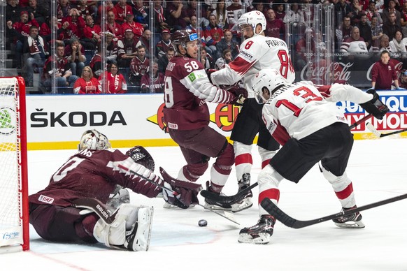 Switzerland&#039;s Nico Hischier scores the 2:1 against Lativa`s Elvis Merzlikins during the game between Latvia and Switzerland, at the IIHF 2019 World Ice Hockey Championships, at the Ondrej Nepela  ...