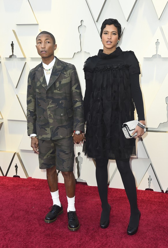 Pharrell Williams, left, and Helen Lasichanh arrives at the Oscars on Sunday, Feb. 24, 2019, at the Dolby Theatre in Los Angeles. (Photo by Jordan Strauss/Invision/AP)