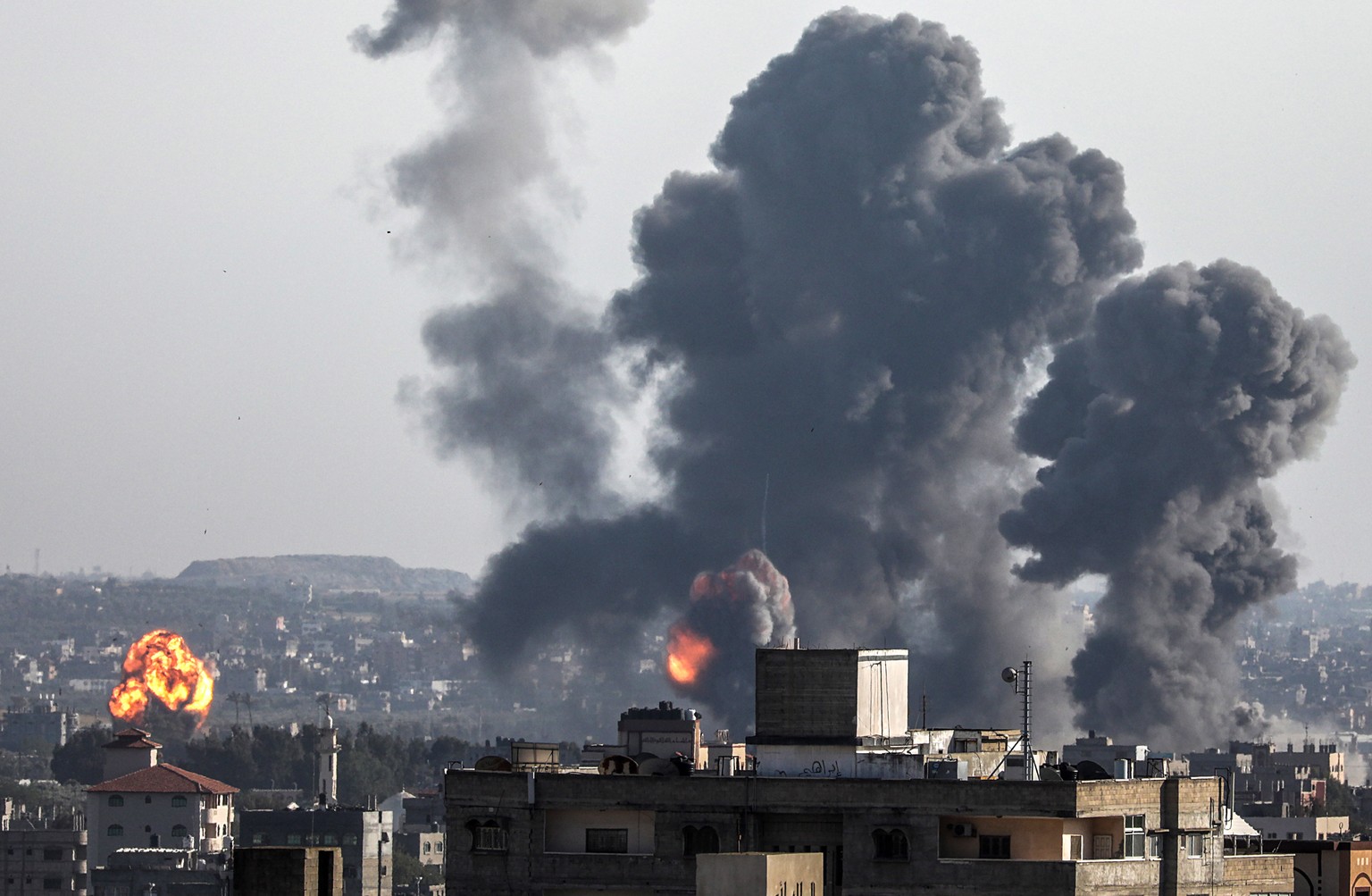 epa07547120 Smoke and flames rise after an Israeli airstrike in Gaza City, 04 May 2019. Reports state five Palestinians were killed, including three in Israeli airstrikes in the Gaza Strip and two dur ...