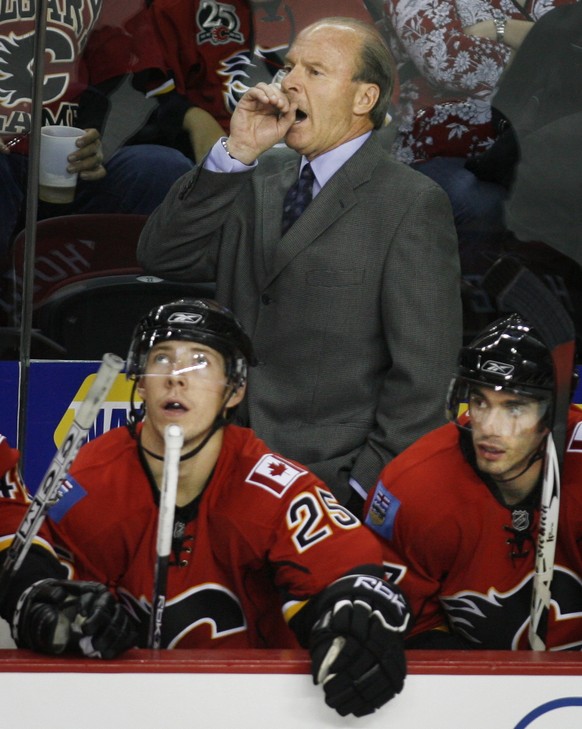 Calgary Flames head coach Mike Keenan, top, shouts as players David Moss, left, and Tim Ramholt look on during third-period NHL pre-season hockey action against the Florida Panthers in Calgary, Canada ...