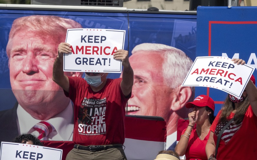 epa08748815 Supporters of US President Donald J Trump attend the Make America Great Again Event with US Vice President Mike Pence at the Cuban Memorial Monument in Miami, Florida, USA, 15 October 2020 ...