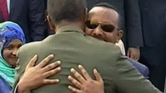 In this grab taken from video provided by ERITV, Ethiopia&#039;s Prime Minister Abiy Ahmed, background centre is welcomed by Erirea&#039;s President Isaias Afwerki as he disembarks the plane, in Asmar ...