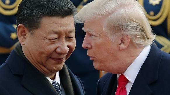 FILE - In this Nov. 9, 2017, file photo, U.S. President Donald Trump, right, chats with Chinese President Xi Jinping during a welcome ceremony at the Great Hall of the People in Beijing. Seeking China ...