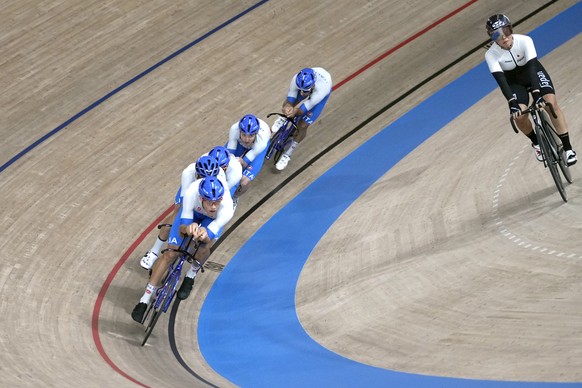 Italian riders round the track past Kisato Nakamura of Japan during a training at the 2020 Summer Olympics, Sunday, Aug. 1, 2021, in Izu, Japan. (AP Photo/Christophe Ena)