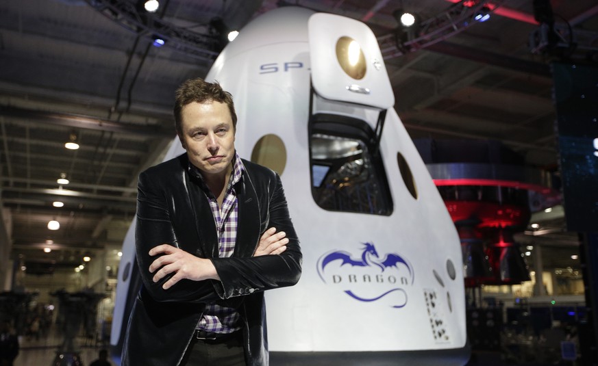 FILE - In this Thursday, May 29, 2014 file photo, Elon Musk, CEO and CTO of SpaceX, listens to a question during a news conference in front of the SpaceX Dragon V2 spacecraft, designed to ferry astron ...