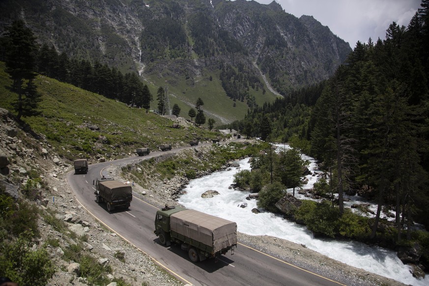 FILE- In this June 17, 2020, file photo, an Indian army convoy moves on the Srinagar- Ladakh highway at Gagangeer, north-east of Srinagar, India, two days after 20 Indian soldiers died in a brawl with ...