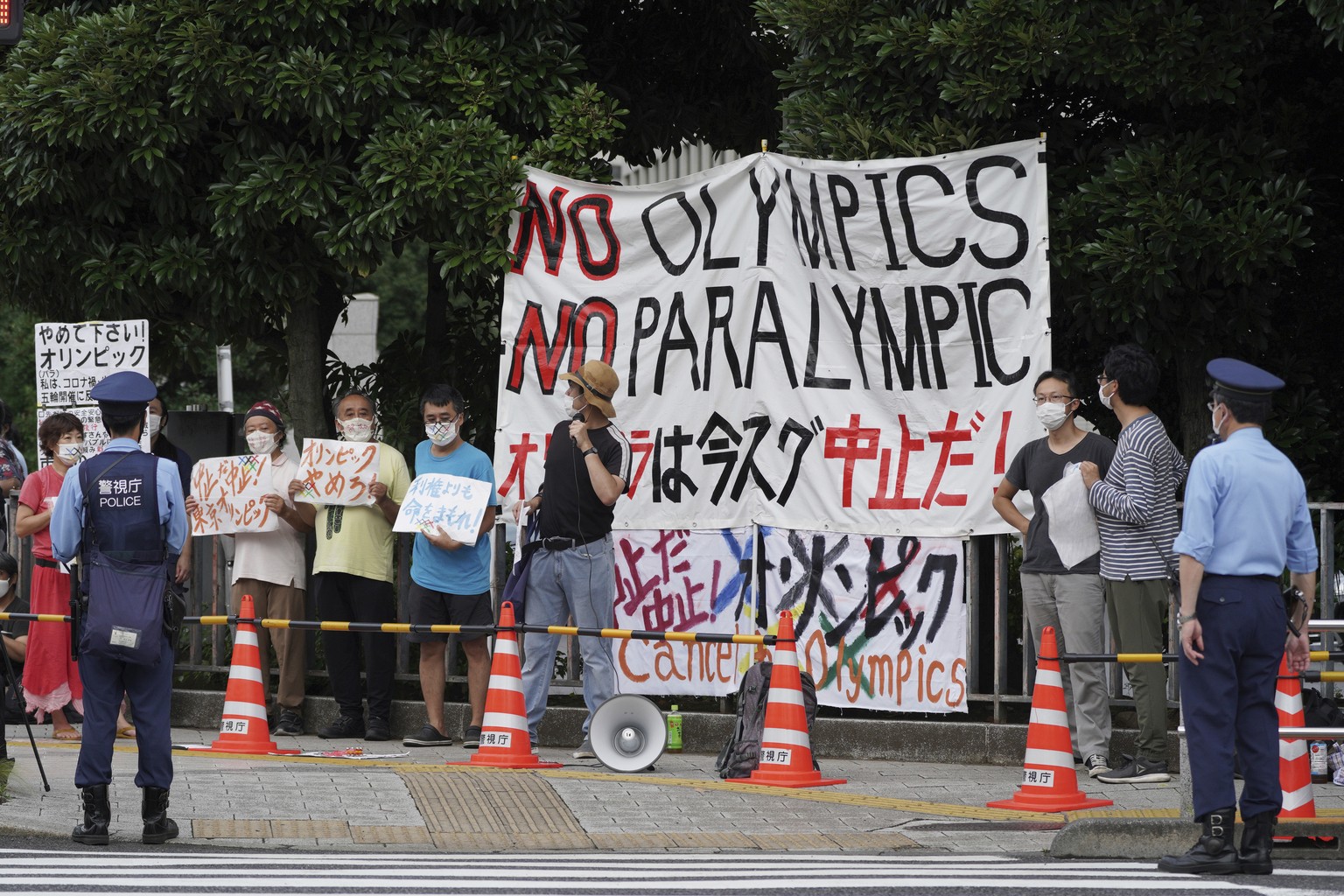 Protesters demonstrate in front of the Prime Minister&#039;s Office in Tokyo, Japan, Monday, Aug. 2, 2021. They were protesting against the Olympics and Paralympics held during the pandemic as Japan h ...