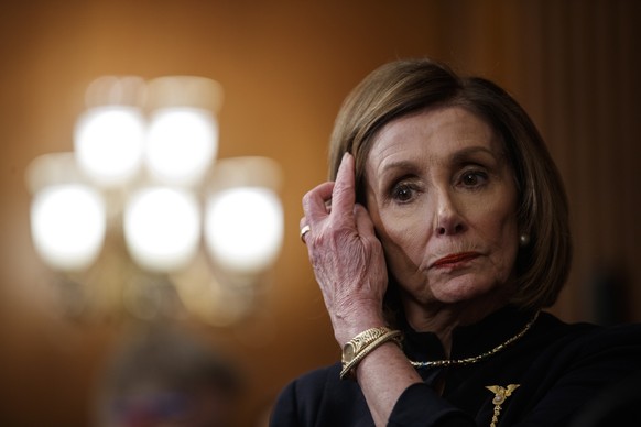 epa08080807 Speaker of the House Nancy Pelosi looks on during a press conference following the impeachment vote of US President Donald J. Trump at the US Capitol in Washington, DC, USA, 18 December 20 ...