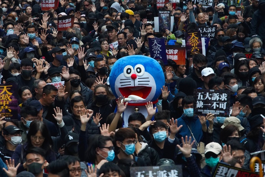Hong Kong people participate in their annual pro-democracy march on New Year&#039;s Day to insist their five demands be matched by the government in Hong Kong, Wednesday, Jan. 1, 2020. The five demand ...