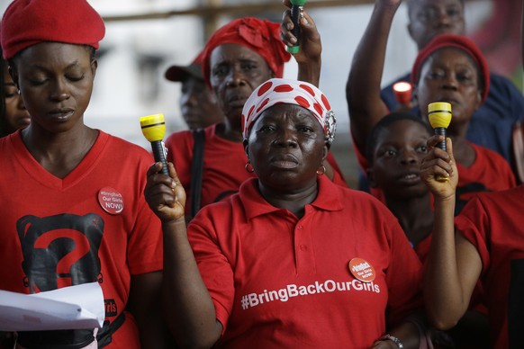 Bring back our girls campaigners hold Torchlights during a vigil to mark three years anniversary of the abduction of girls studying at the Chibok government secondary school in Lagos, Nigeria Friday,  ...