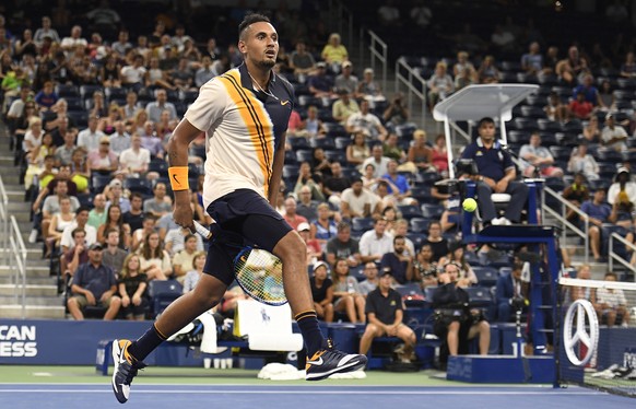 epa06979937 Nick Kyrgios of Australia hits a return between the legs to Radu Albot of Moldova on the second day of the US Open Tennis Championships the USTA National Tennis Center in Flushing Meadows, ...