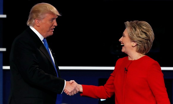 Republican U.S. presidential nominee Donald Trump and Democratic U.S. presidential nominee Hillary Clinton shake hands at the end of their first presidential debate at Hofstra University in Hempstead, ...