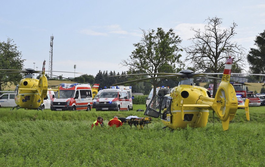 Rescue helicopters stand on a meadow after a train derailed near St. Poelten, Austria, Tuesday, June 26, 2018. Two people were seriously injured when the passenger train derailed on the local railway. ...