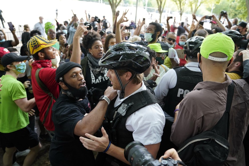 Demonstrators argue with uniformed U.S Secret Service police officers during a protest about the death of George Floyd, a black man who died in police custody in Minneapolis, Friday, May 29, 2020, in  ...