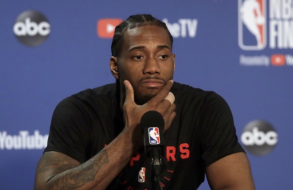 Toronto Raptors forward Kawhi Leonard speaks to reporters before a team practice in Oakland, Calif., Wednesday, June 12, 2019. The Raptors are scheduled to play the Golden State Warriors in Game 6 of  ...