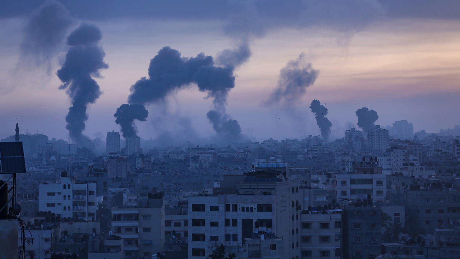 epa09192927 Smoke and flames rise after an Israeli airstrike on Gaza City, 12 May 2021. At least one woman was killed after 130 rockets, fired by Hamas from the Gaza strip, fell on Tel Aviv and neighb ...