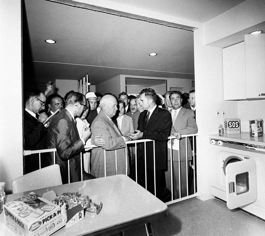 U.S. Vice President Richard Nixon, center, and Soviet Premier Nikita Khrushchev, left center, are engaged in a discussion as they stand in front of a kitchen display at the United States exhibit at Mo ...