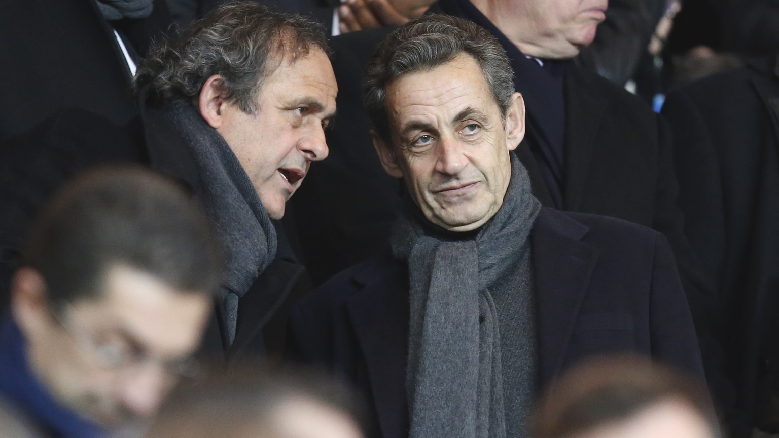 Former French President Nicolas Sarkozy, right, listens to UEFA President Michel Platini, before the Champions League round of 16 first leg soccer match between Paris Saint Germain and Chelsea at the  ...