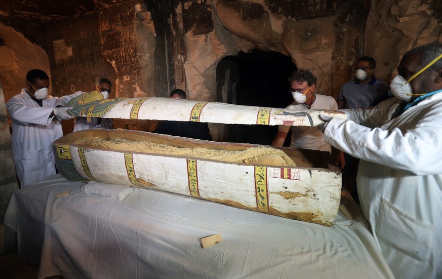 epa07186564 Egyptian archaeologists move the cover of an intact sarcophagus, inside Tomb TT33 in Luxor, 700km south of Cairo, Egypt, 24 Novmber 2018. Earlier this month the French mission in Luxor dis ...