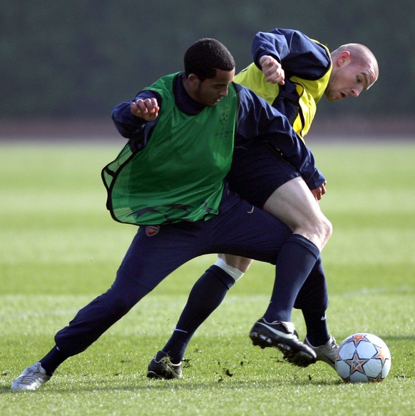 Arsenal&#039;s Theo Walcott, right, grapples with Philippe Senderos during their training session, London Colney Tuesday Feb. 19, 2008. Arsenal will face AC Milan in a Champions League round of 16 soc ...
