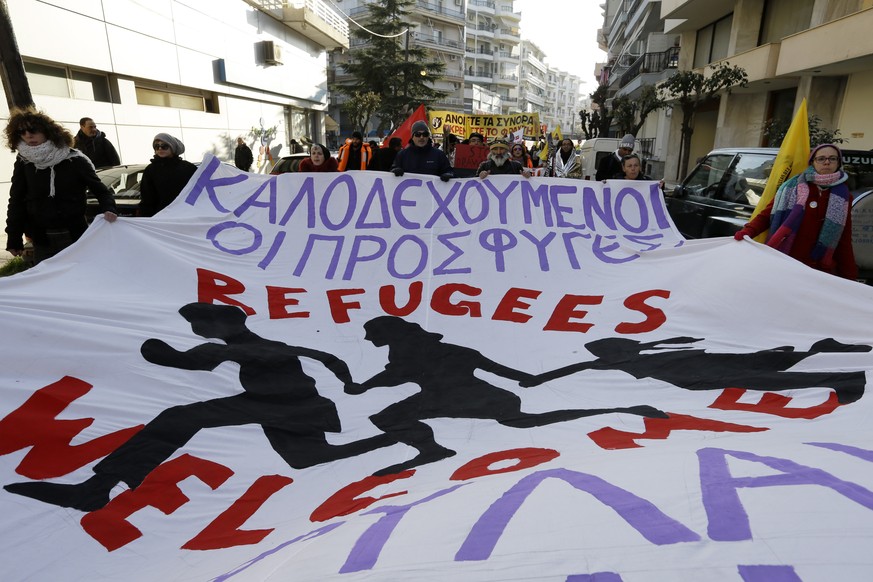 A left-wing group holds a banner reading in Greek and English &quot;refugees welcome&quot; during a solidarity rally for the refugees and migrants at the border town of Alexandroupolis, northeastern G ...