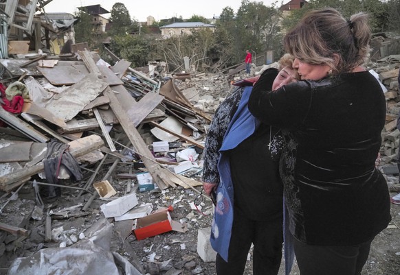 A neighbour comforts home owner, Lida Sarksyan, left, near her house destroyed by shelling from Azerbaijan&#039;s artillery during a military conflict in Stepanakert, the separatist region of Nagorno- ...
