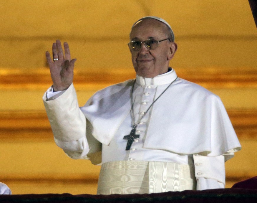 Pope Francis waves to the crowd from the central balcony of St. Peter&#039;s Basilica at the Vatican, Wednesday, March 13, 2013. Cardinal Jorge Bergoglio who chose the name of Francis is the 266th pon ...