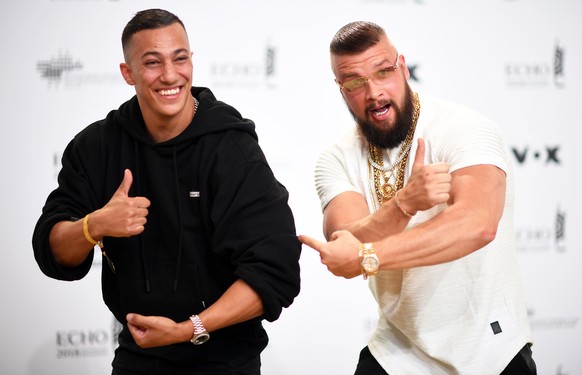 epa06664881 German musicians Kollegah (R) and Farid Bang (L) pose on the red carpet as they attend the 27th Echo 2018 music awards in Berlin, Germany, 12 April 2018. The awards are presented for outst ...