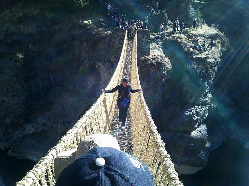 epa04245986 An undated handout photo releaded on 08 June 2014 by the Peruvian Culture Ministry shows a woman crossing the suspension bridge Q&#039;eswachaka in Cuzco region, Peru. UNESCO delivered a d ...