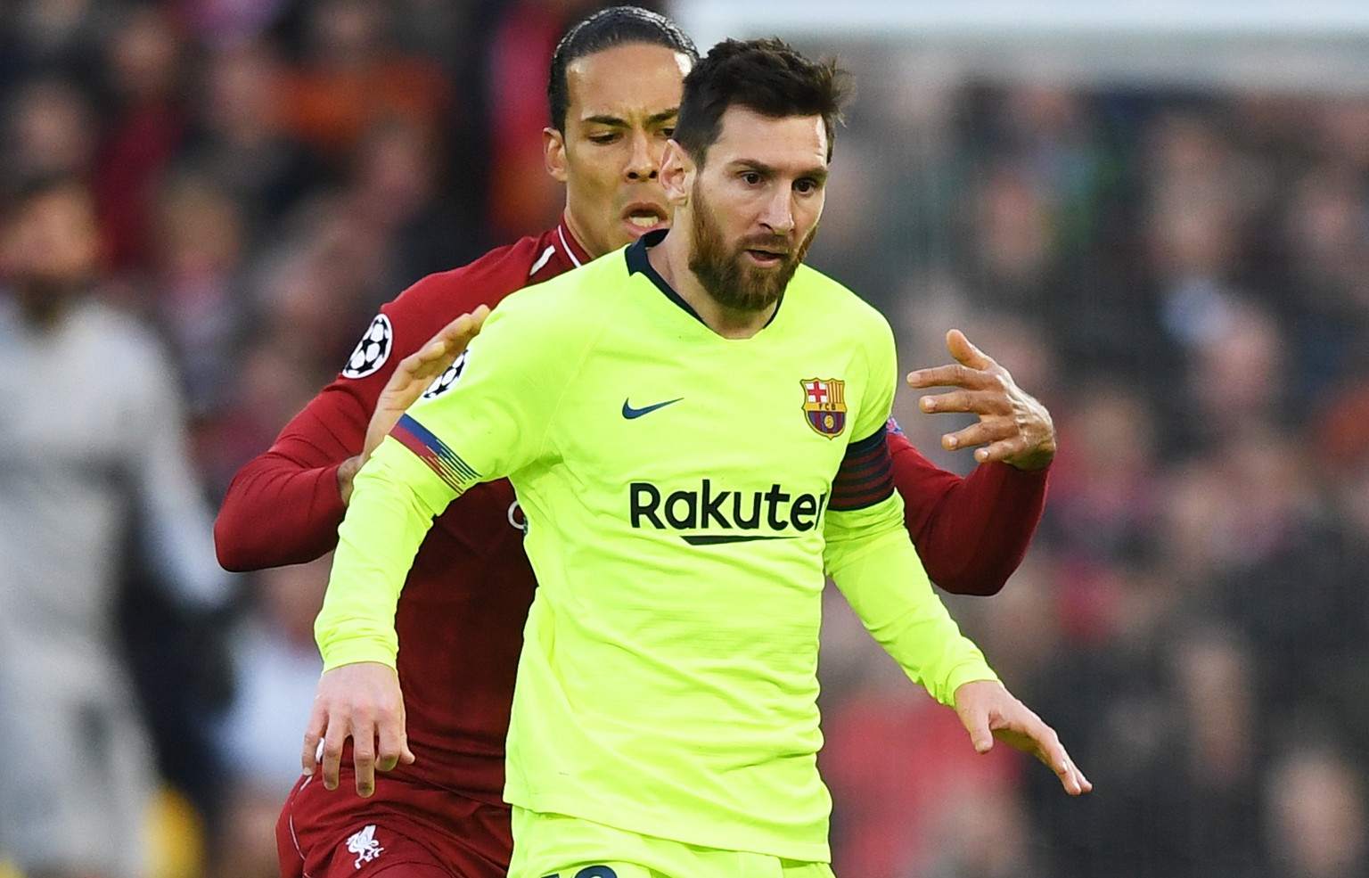 epa07554479 Virgil Van Dijk of Liverpool and Lionel Messi (front) of Barcelona in action during the UEFA Champions League semi final second leg soccer match between Liverpool FC and FC Barcelona at An ...