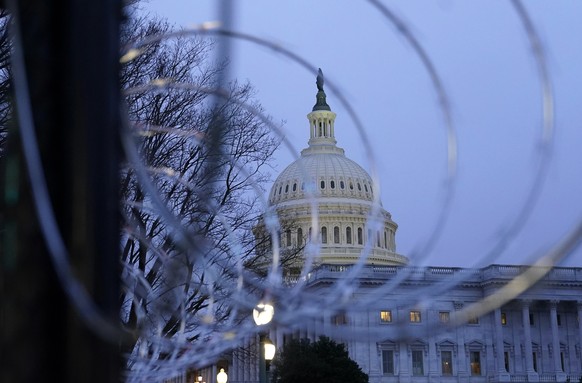 The U.S. Capitol dome is seen past security fencing and barbed wire in Washington, Saturday, Jan. 16, 2021, as preparations take place for President-elect Joe Biden&#039;s inauguration ceremony. (AP P ...