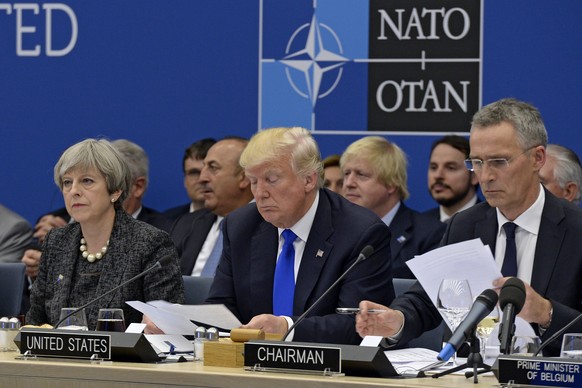 epa05989957 Britain&#039;s Prime Minister Theresa May, US President Donald Trump and NATO Secretary General Jens Stoltenberg during a working dinner meeting at the NATO summit in Brussels, Belgium, 25 ...